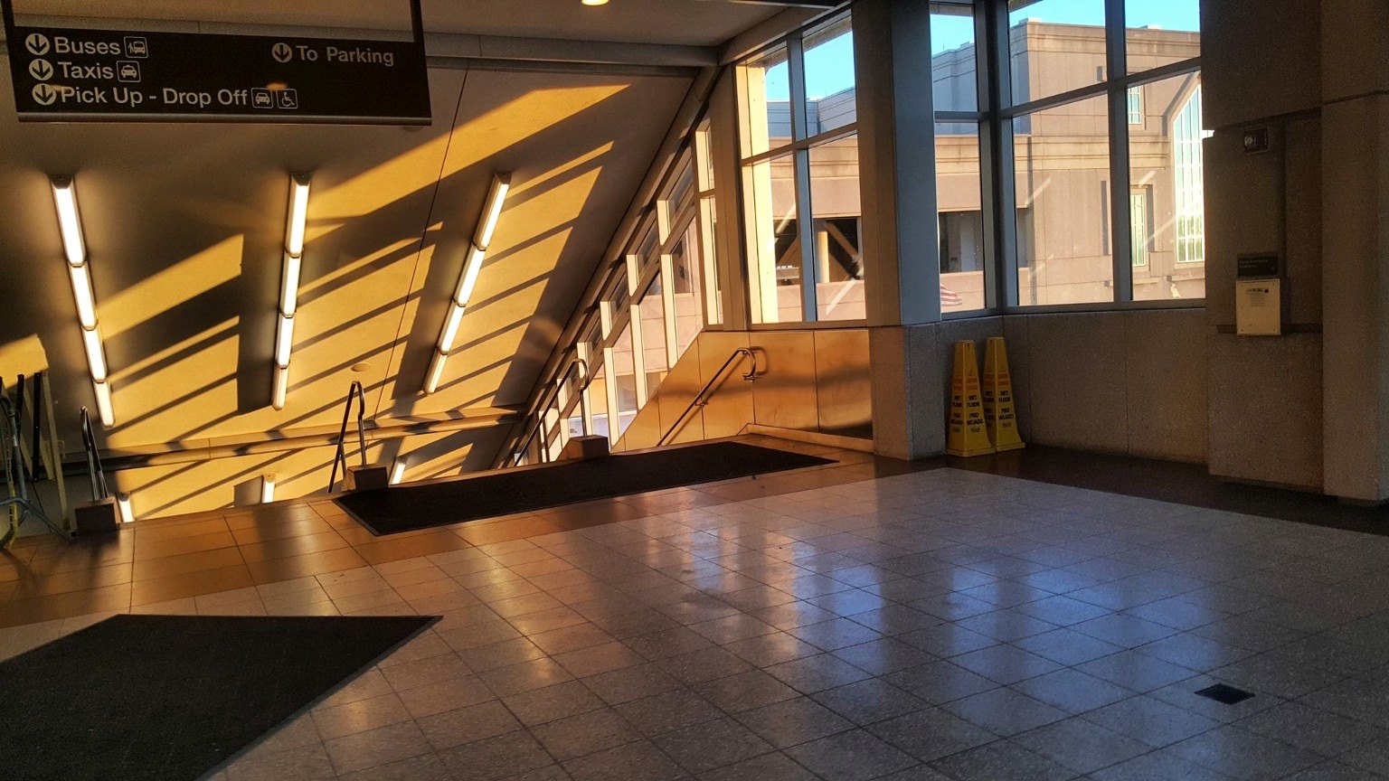 Golden light falling across a transit station interior